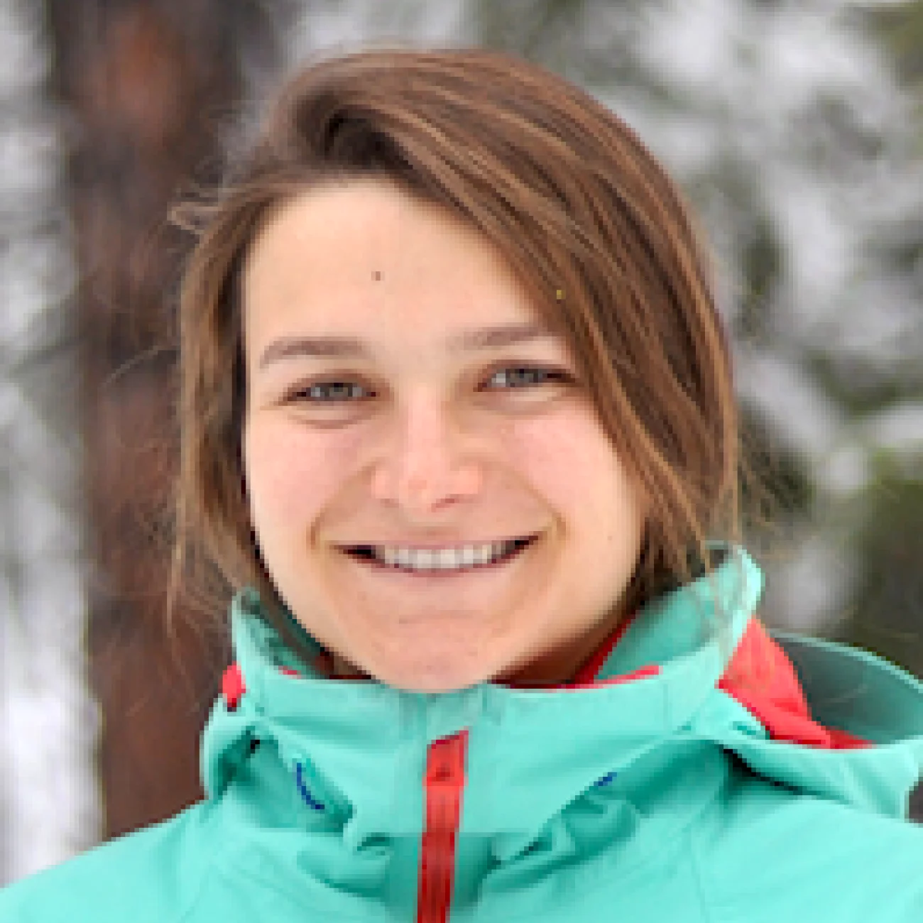 A headshot of Elina Robeva with snow covered trees in the background