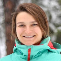 A headshot of Elina Robeva with snow covered trees in the background
